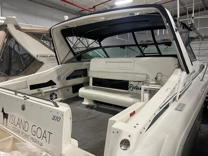 Slide: The Image of 1992 Sea Ray 370 Sundancer boat docked at marina, featuring spacious seating area. - 13