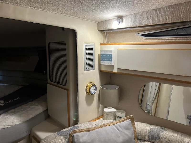 Slide: The Image of Interior of 1992 Sea Ray 370 Sundancer yacht, featuring cozy seating and elegant decor. - 5