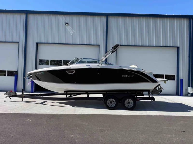 The Image of 2021 Cobalt R5 boat on trailer in front of warehouse. - 1