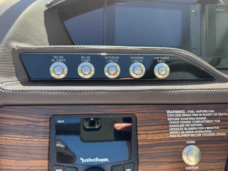 Slide: The Image of Dashboard of a Cobalt R5 boat with controls and warning labels. - 16