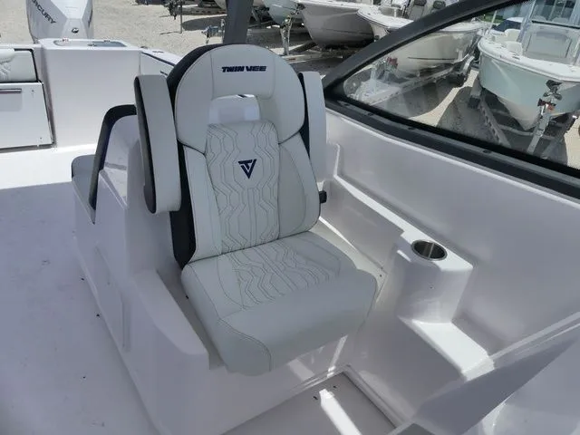 Slide: The Image of Interior of 2026 Twin Vee 280 GFX2 DUAL CONSOLE with luxurious seating. - 13