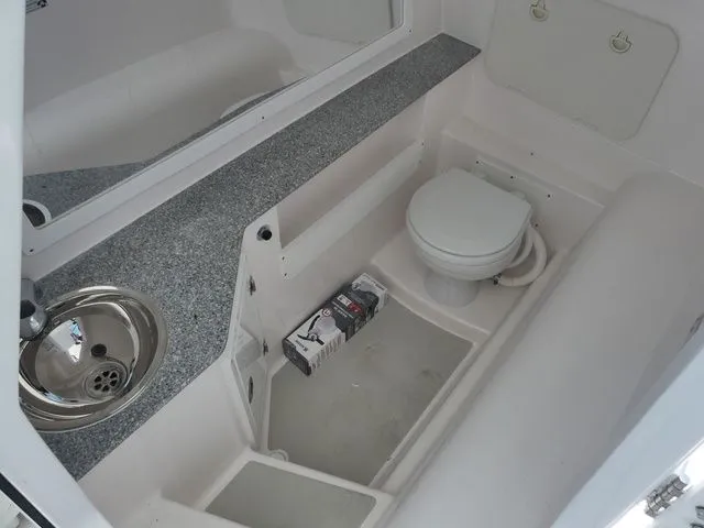 Slide: The Image of Interior of 2026 Twin Vee 280 GFX2 DUAL CONSOLE with toilet and sink. - 14