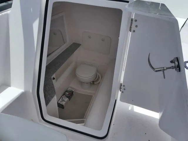Slide: The Image of Interior of Twin Vee 280 GFX2 DUAL CONSOLE 2026 with toilet. - 15
