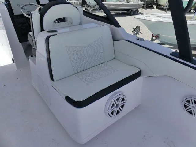 Slide: The Image of Interior of 2026 Twin Vee 280 GFX2 DUAL CONSOLE with seating and speaker. - 9