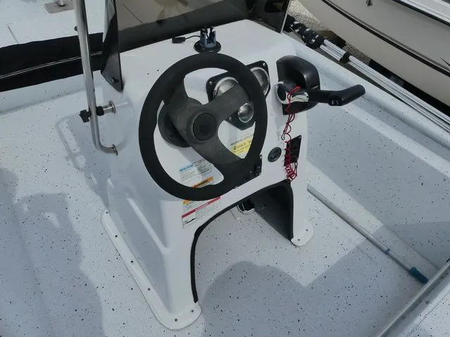 Slide: The Image of 2021 Xpress Boats XP18CC steering console with wheel and throttle control. - 10