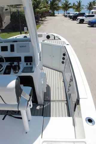 Slide: The Image of 2023 Yamaha Boats 222 FSH Sport E parked near the beach. - 13
