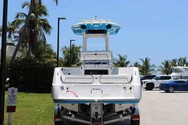 Slide: The Image of Rear view of a 2023 Yamaha 222 FSH Sport E boat outdoors. - 5