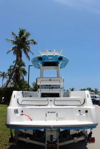 Slide: The Image of Rear view of 2023 Yamaha 222 FSH Sport E boat under palm trees. - 6