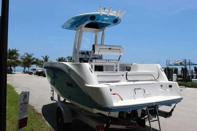 Slide: The Image of 2023 Yamaha Boats 222 FSH Sport E on trailer by the beach. - 7