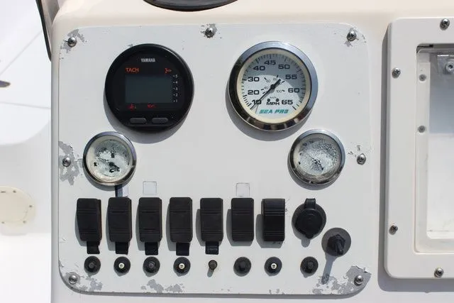 Slide: The Image of Dashboard of a 2001 Sea Pro 2100 SV boat with tachometer and switches. - 17