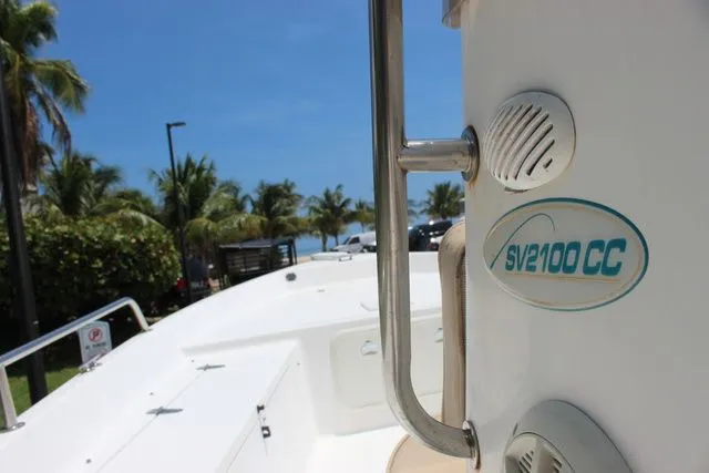 Slide: The Image of Sea Pro 2100 SV boat, 2001 model, sunny day, palm trees in background. - 21