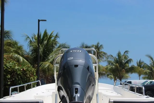 Slide: The Image of 2001 Sea Pro 2100 SV boat with palm trees in the background. - 28