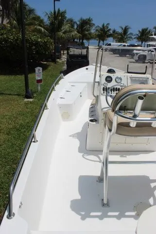 Slide: The Image of 2001 Sea Pro 2100 SV boat with helm console and palm trees in background. - 8