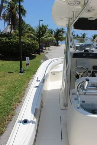 Slide: The Image of 2014 Pioneer 222 Sportfish boat parked by tropical shore. - 14