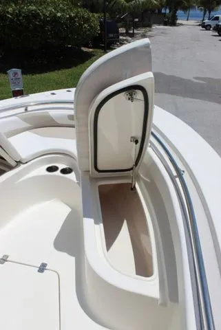 Slide: The Image of 2014 Pioneer 222 Sportfish boat with open storage compartment. - 21