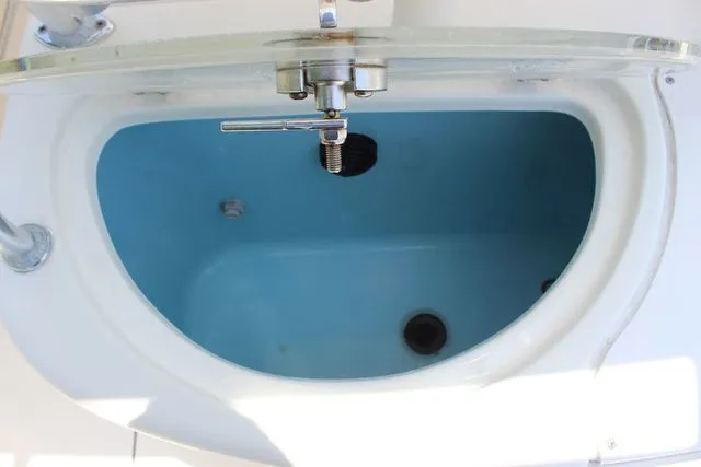 Slide: The Image of Pioneer 222 Sportfish 2014 boat livewell with blue interior. - 27