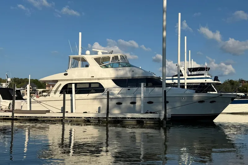The Image of 2006 Carver 56 Voyager yacht docked at marina under clear blue sky. - 0