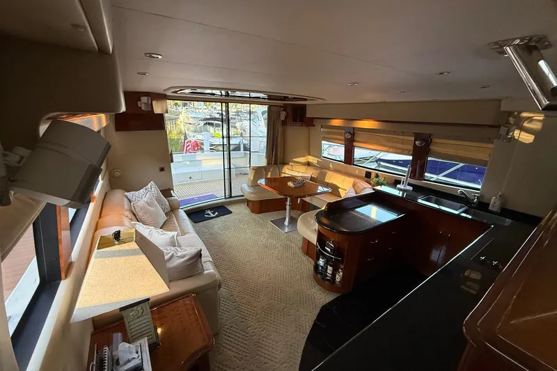 Slide: The Image of Luxurious interior of a 2006 Carver 56 Voyager yacht with elegant seating and kitchen area. - 11