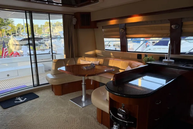 Slide: The Image of Luxurious interior of a 2006 Carver 56 Voyager yacht with elegant seating and dining area. - 12