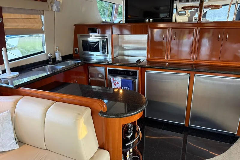 Slide: The Image of Luxurious kitchen interior of 2006 Carver 56 Voyager yacht with modern appliances and wood cabinetry. - 14