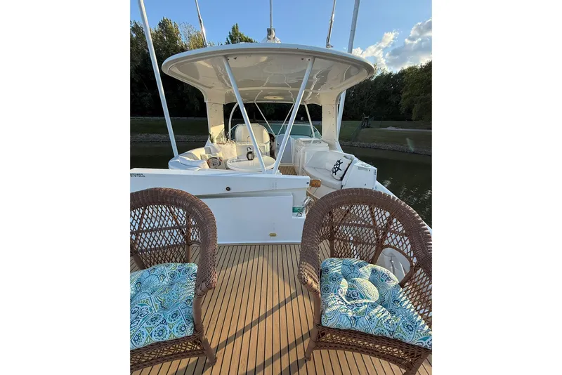 Slide: The Image of 2006 Carver 56 Voyager yacht deck with wicker chairs and scenic view. - 16