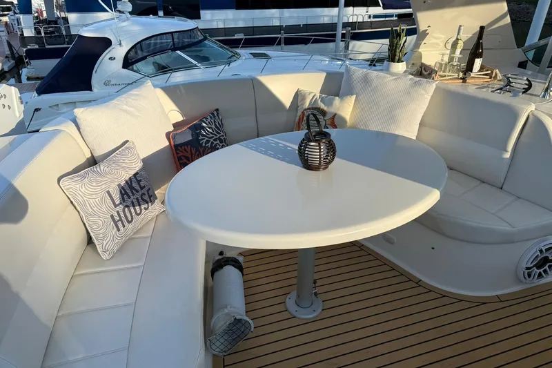 Slide: The Image of Luxurious seating area on 2006 Carver 56 Voyager yacht with decorative pillows and table. - 17