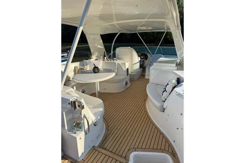 Slide: The Image of Luxurious 2006 Carver 56 Voyager yacht interior with elegant seating and table setup. - 19