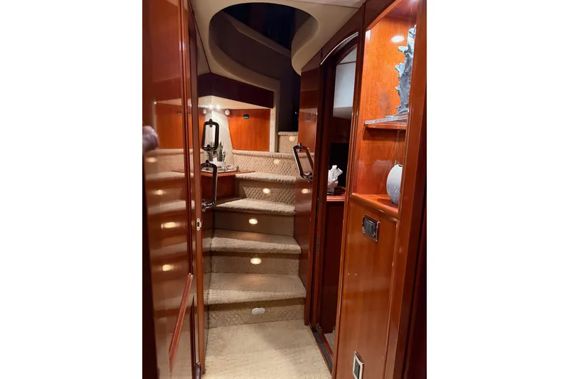 Slide: The Image of Luxurious interior of 2006 Carver 56 Voyager yacht with elegant wooden staircase. - 20