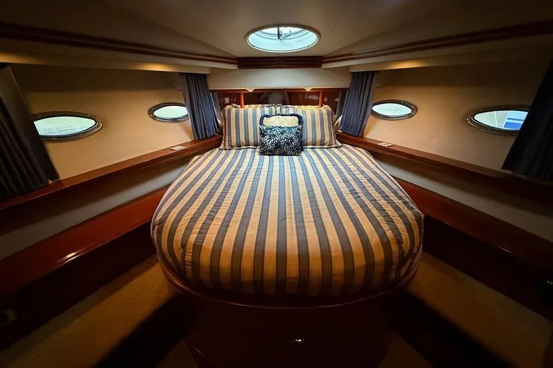 Slide: The Image of Luxurious bedroom interior of 2006 Carver 56 Voyager yacht with striped bedding. - 23