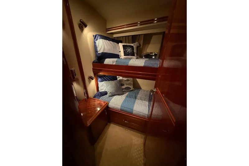 Slide: The Image of Luxurious 2006 Carver 56 Voyager yacht cabin with cozy bunk beds and nautical decor. - 24