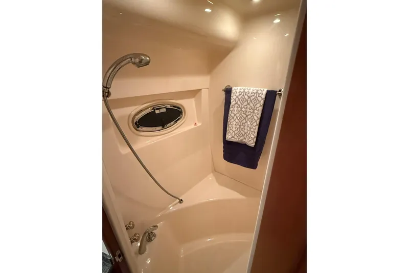 Slide: The Image of Shower area in 2006 Carver 56 Voyager yacht with towel and porthole window. - 25