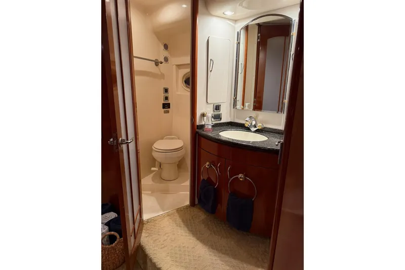 Slide: The Image of Luxurious bathroom in 2006 Carver 56 Voyager yacht with elegant fixtures and wood accents. - 26