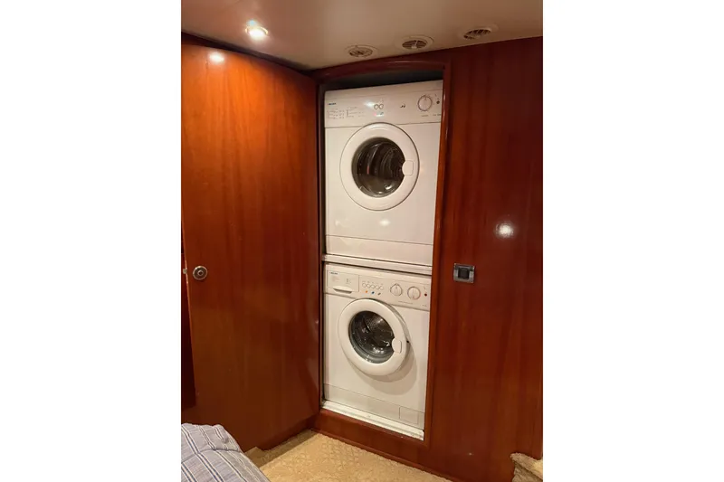 Slide: The Image of Stacked washer and dryer in 2006 Carver 56 Voyager yacht's wooden interior. - 27
