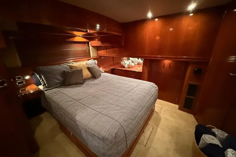 Slide: The Image of Luxurious bedroom interior of 2006 Carver 56 Voyager yacht with elegant wood finish. - 28