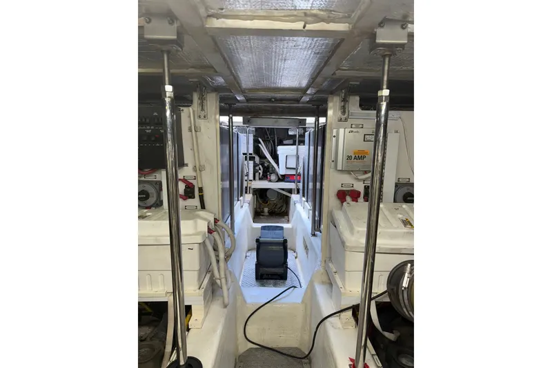 Slide: The Image of Engine room of a 2006 Carver 56 Voyager yacht, showcasing equipment and wiring. - 29