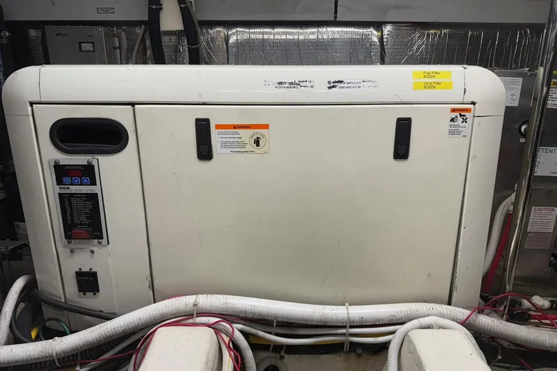 Slide: The Image of Engine room of a 2006 Carver 56 Voyager yacht with equipment and wiring. - 31