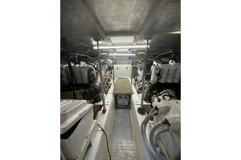 Slide: The Image of Engine room of a 2006 Carver 56 Voyager yacht, showcasing mechanical components and equipment. - 32