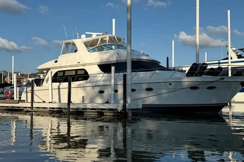 Slide: The Image of 2006 Carver 56 Voyager yacht docked at marina under blue sky. - 6