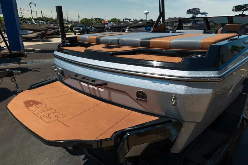 Slide: The Image of 2025 Axis A225 boat with sleek design and spacious seating at a dealership. - 10