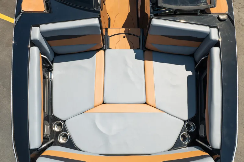 Slide: The Image of 2025 Axis A225 boat interior with gray and tan seating, viewed from above. - 19