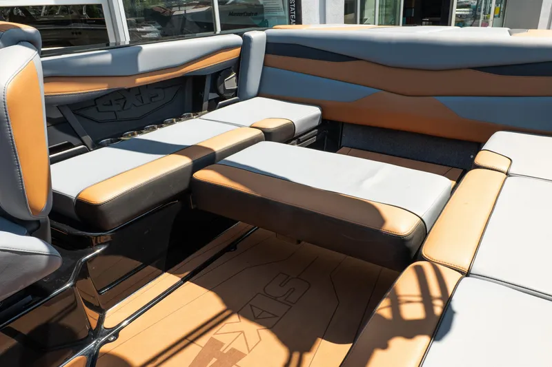 Slide: The Image of 2025 Axis A225 boat interior with tan and gray seating arrangement. - 28