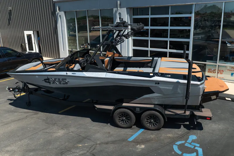 Slide: The Image of 2025 Axis A225 boat on trailer outside dealership, showcasing sleek design and modern features. - 3