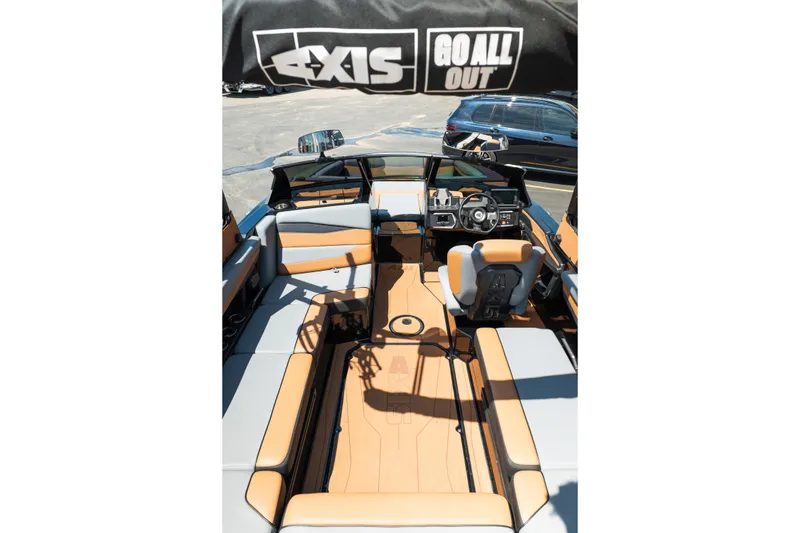 Slide: The Image of 2025 Axis A225 boat interior with tan and gray seating, steering wheel, and dashboard. - 30
