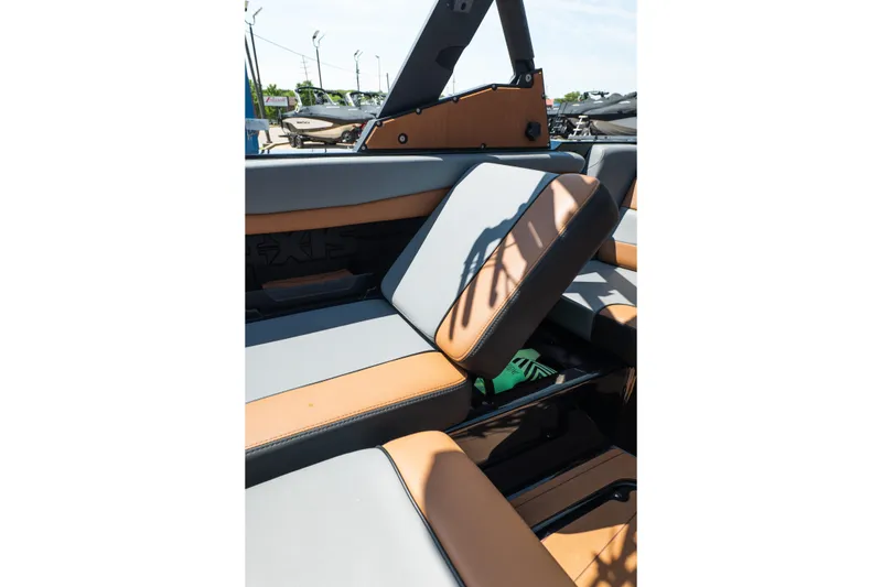 Slide: The Image of 2025 Axis A225 boat interior with tan and gray seating, showcasing modern design. - 31
