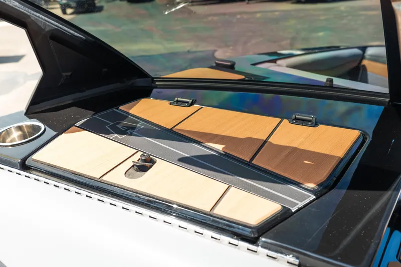 Slide: The Image of 2025 Axis A225 boat dashboard with wood accents and cup holder. - 33