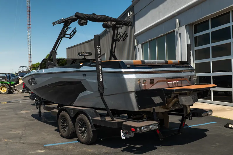 Slide: The Image of 2025 Axis A225 boat on trailer outside a modern building. - 4