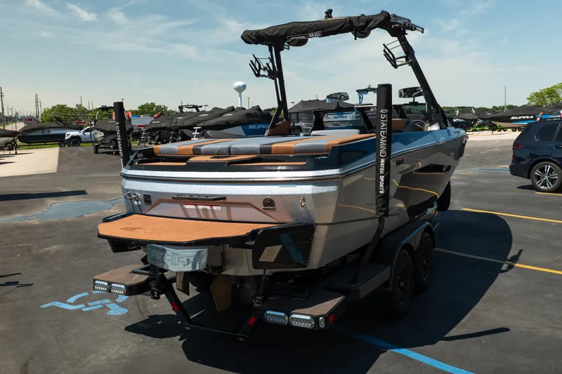 Slide: The Image of 2025 Axis A225 boat on trailer in parking lot, showcasing sleek design and modern features. - 7