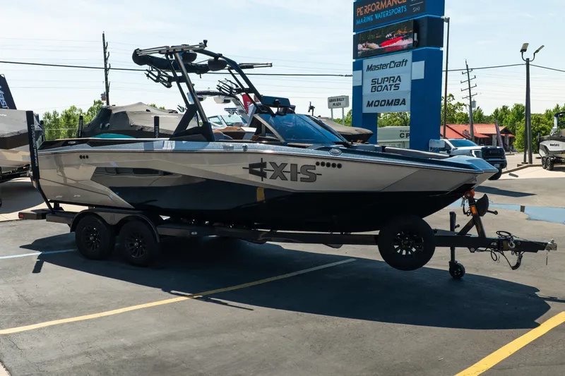 Slide: The Image of 2025 Axis A225 boat on trailer at a marine dealership. - 8