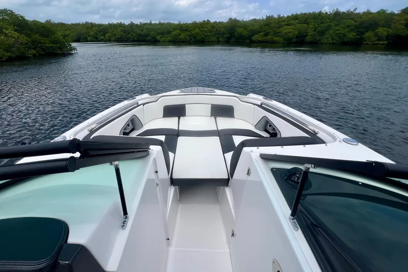 Slide: The Image of 2024 Monterey M-45 boat interior with sleek seating, cruising on a serene lake. - 11