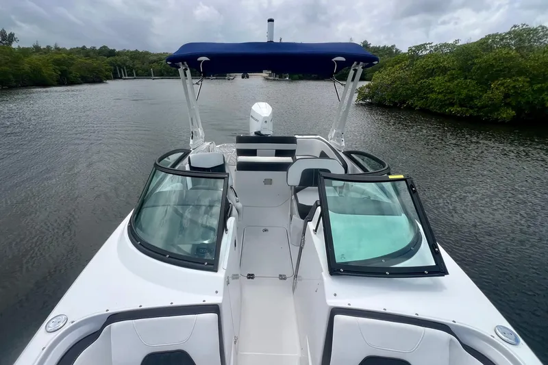 Slide: The Image of 2024 Monterey M-45 boat with blue canopy cruising on a serene river. - 14